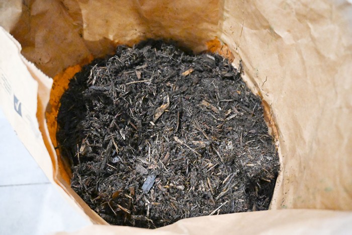 This photo shows a bag of the media (carboxymethylcelluloseâ€“iron) dried on Cedar bark.